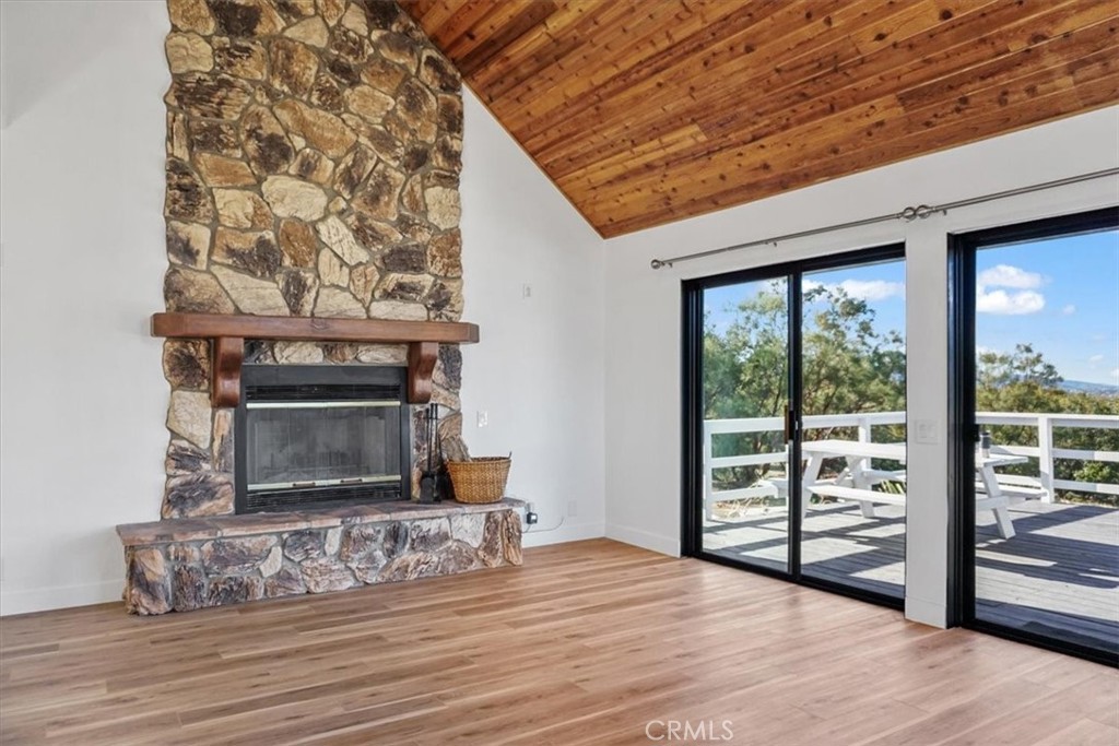 59470 Burnt Valley Road Anza, CA 92539 - Photo 8 of 18 a view of empty room with wooden floor and fireplace