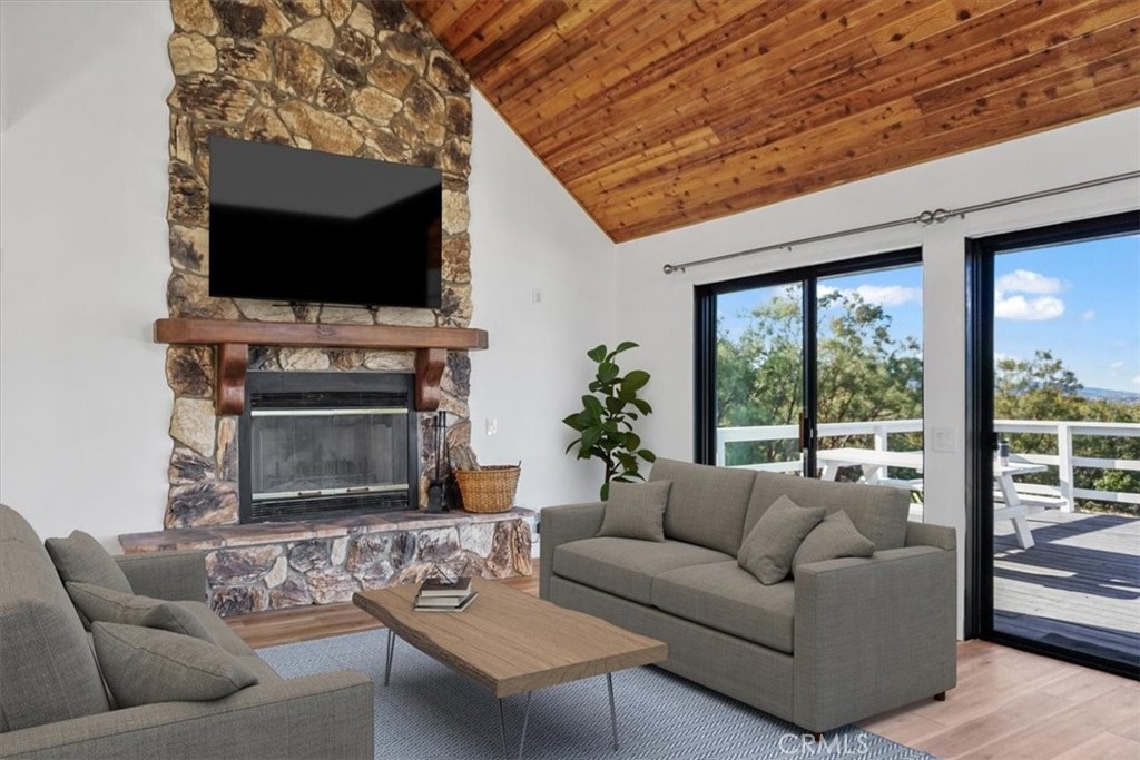 59470 Burnt Valley Road Anza, CA 92539 - Photo 9 of 18 a living room with furniture a flat screen tv and a fireplace