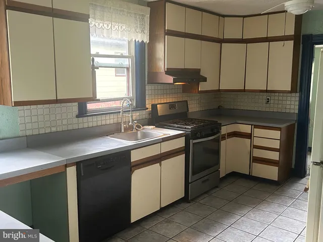 a kitchen that has a sink and a stove