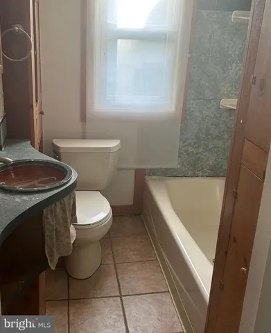 a bathroom with a toilet a sink and bathtub