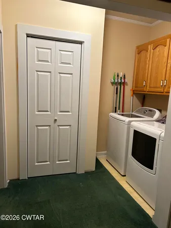 a view of a kitchen with fridge and wooden floor