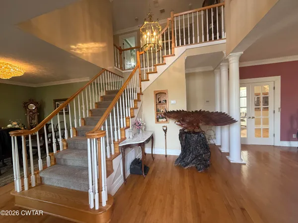 a view of entryway and hall with wooden floor