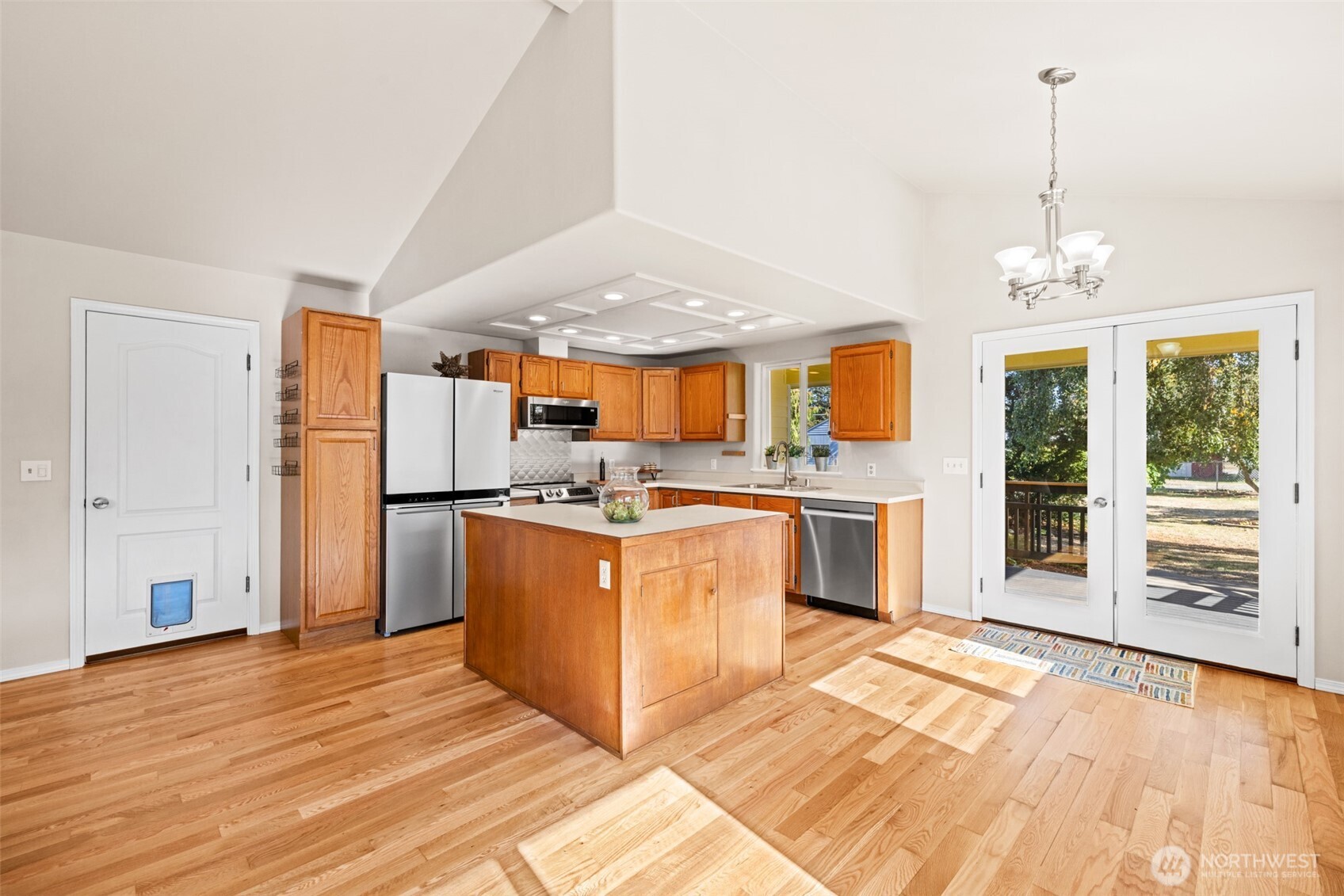 92 Robbins Road Sequim, WA 98382 - Photo 24 of 39 a kitchen with stainless steel appliances granite countertop a refrigerator a oven a stove and a wooden floors