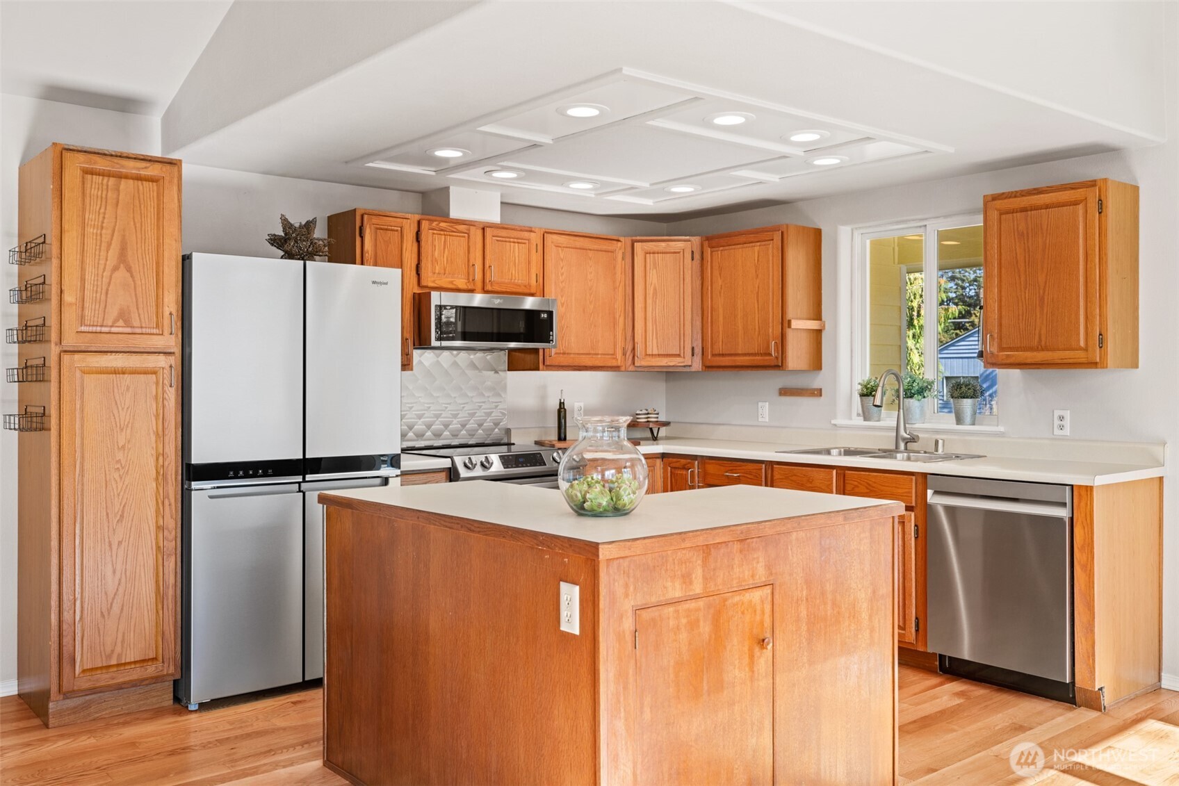 92 Robbins Road Sequim, WA 98382 - Photo 25 of 39 a kitchen with a refrigerator a stove a sink dishwasher and wooden cabinets
