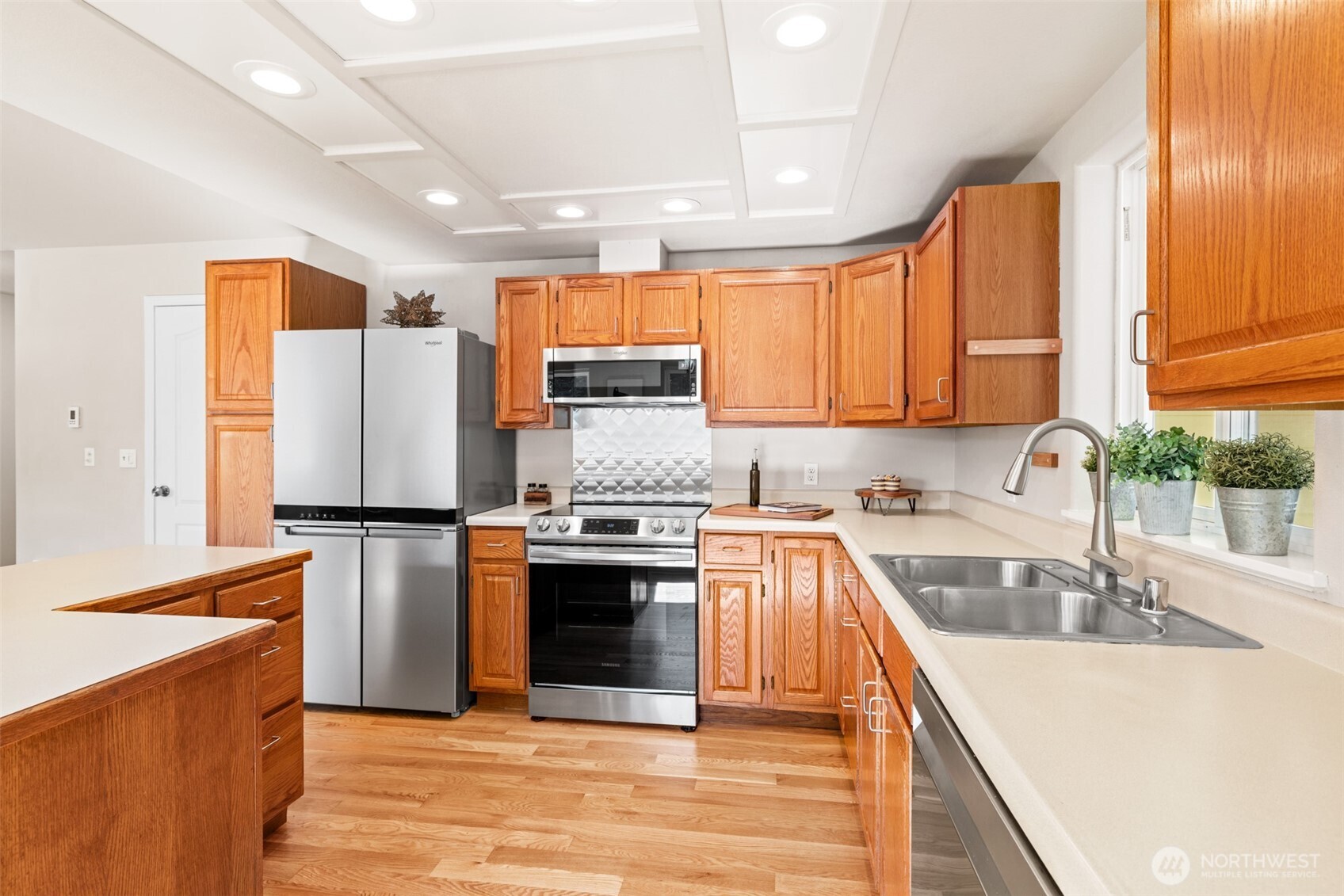 92 Robbins Road Sequim, WA 98382 - Photo 28 of 39 a kitchen with stainless steel appliances granite countertop a refrigerator a sink dishwasher a stove top oven a counter space and cabinets