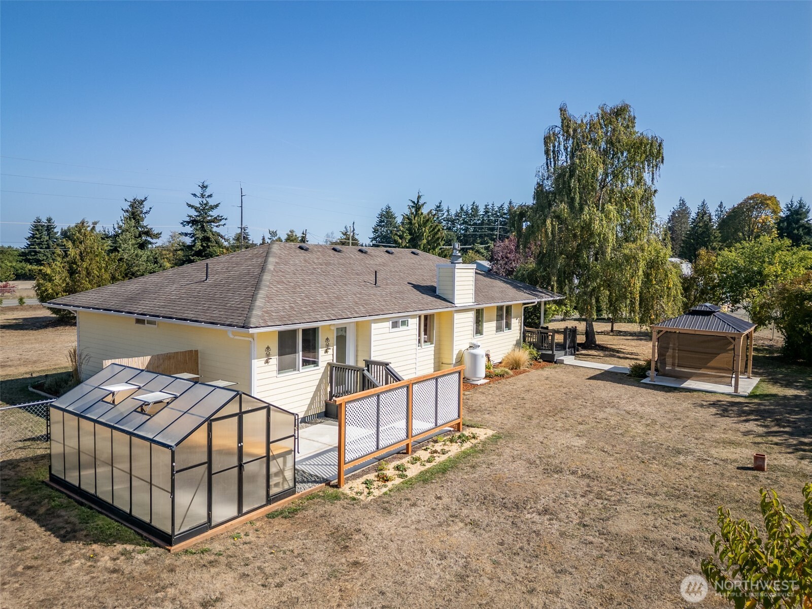 92 Robbins Road Sequim, WA 98382 - Photo 7 of 39 a view of a house with backyard and sitting area