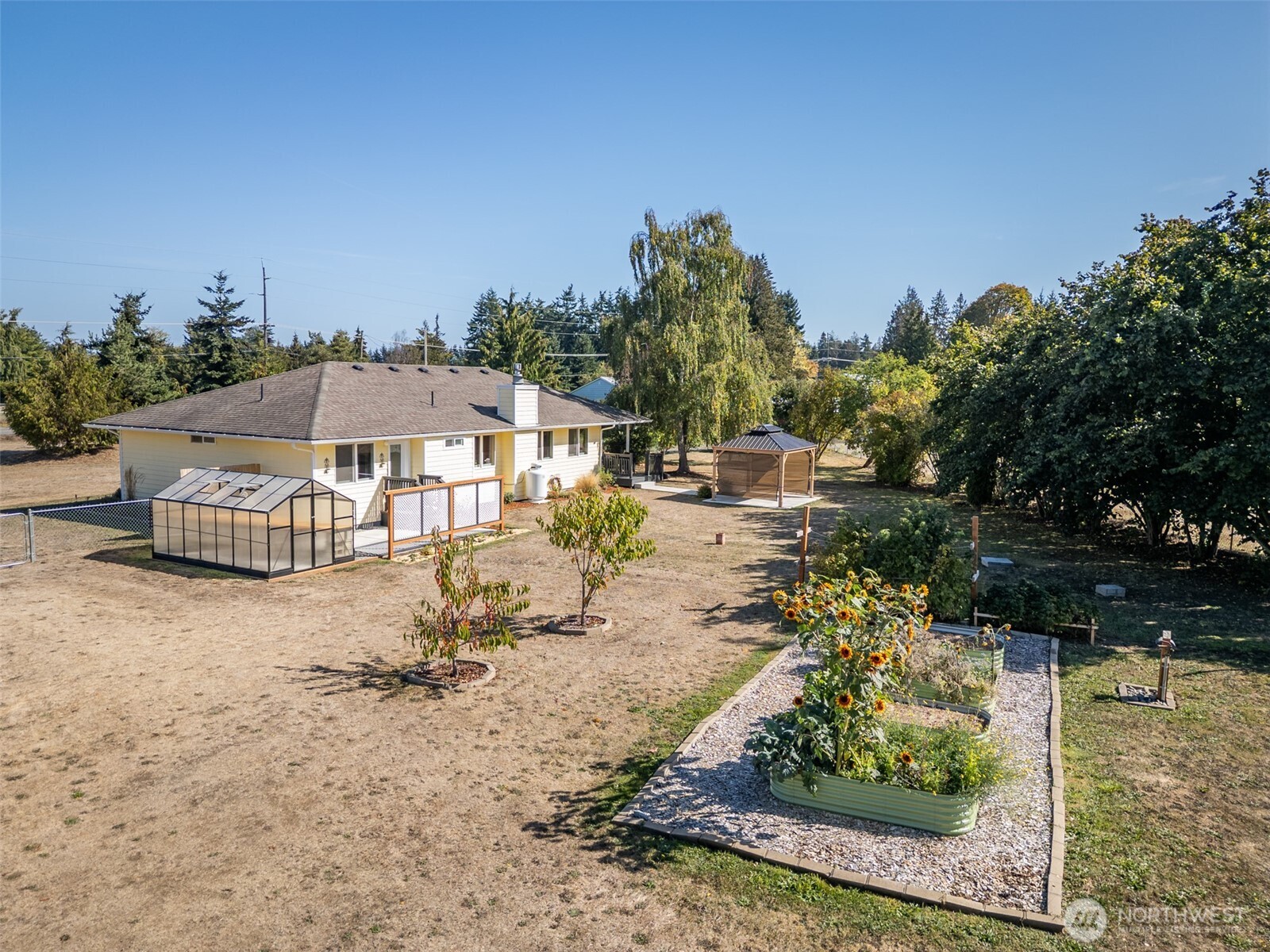 92 Robbins Road Sequim, WA 98382 - Photo 8 of 39 a view of a swimming pool with lawn chairs under an umbrella