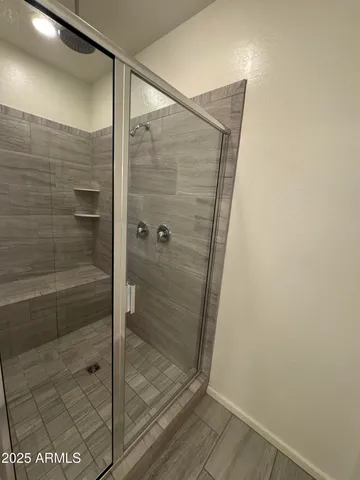 a spacious bathroom with a double vanity sink and a mirror