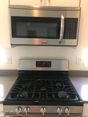 a kitchen with granite countertop a refrigerator and a sink