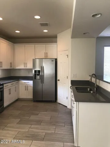 a kitchen with a sink and a refrigerator