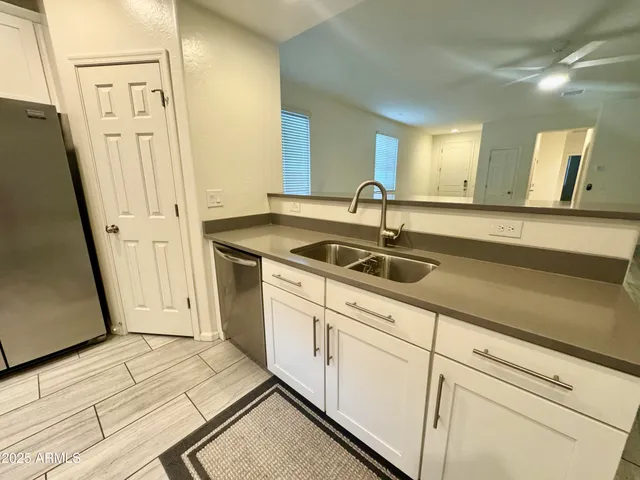 a kitchen with stainless steel appliances white cabinets and a stove a oven with wooden floor