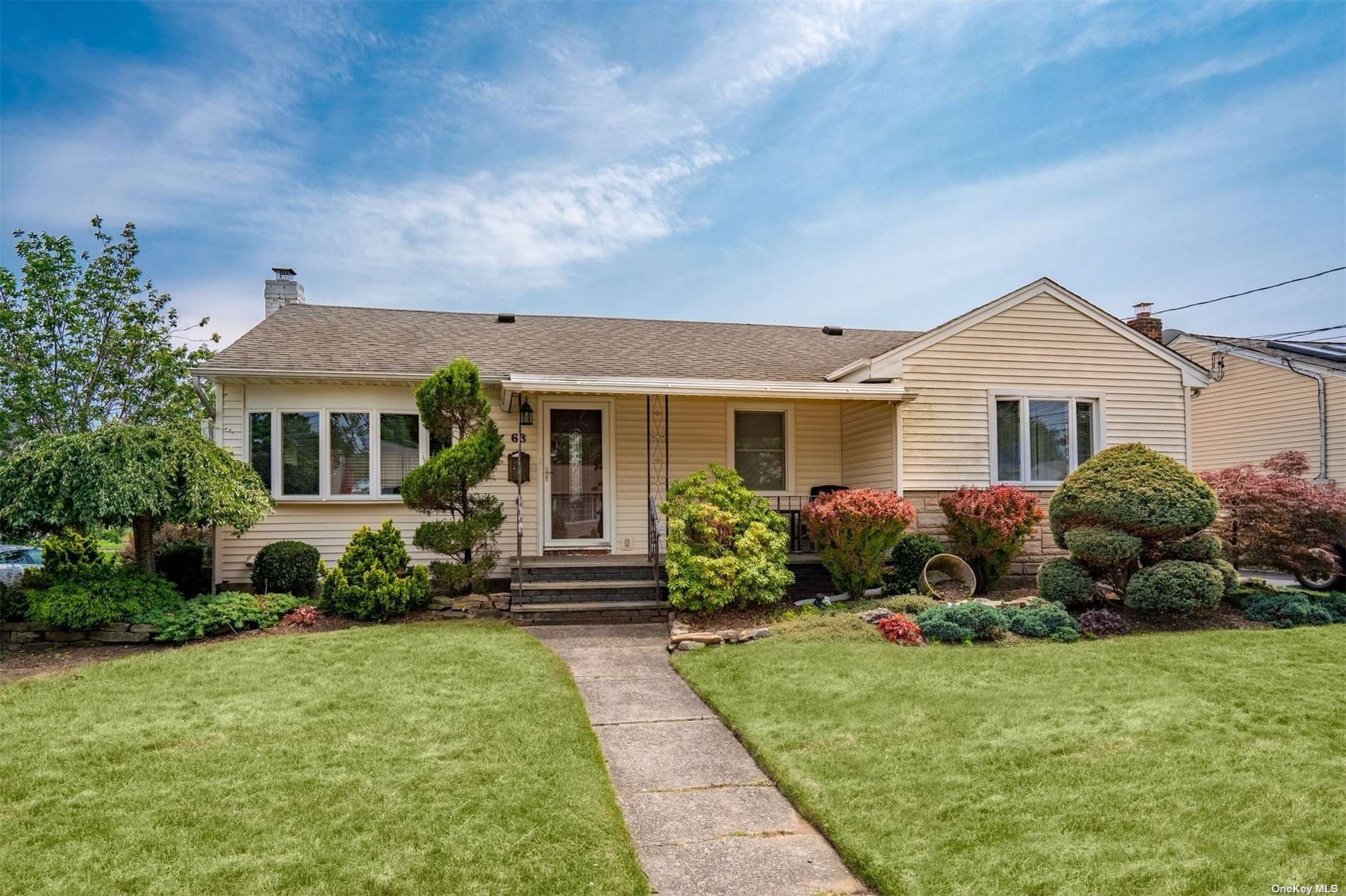 63 Martin Road North Bethpage, NY 11714 - Photo 1 of 1 a front view of a house with a yard and porch