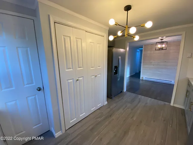 a view of a hallway with wooden floor