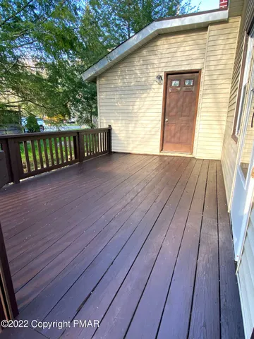 a view of a wooden deck besides a house