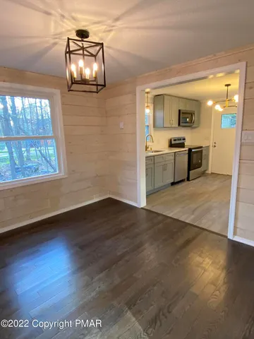 a view of a living room with hardwood floor and a window