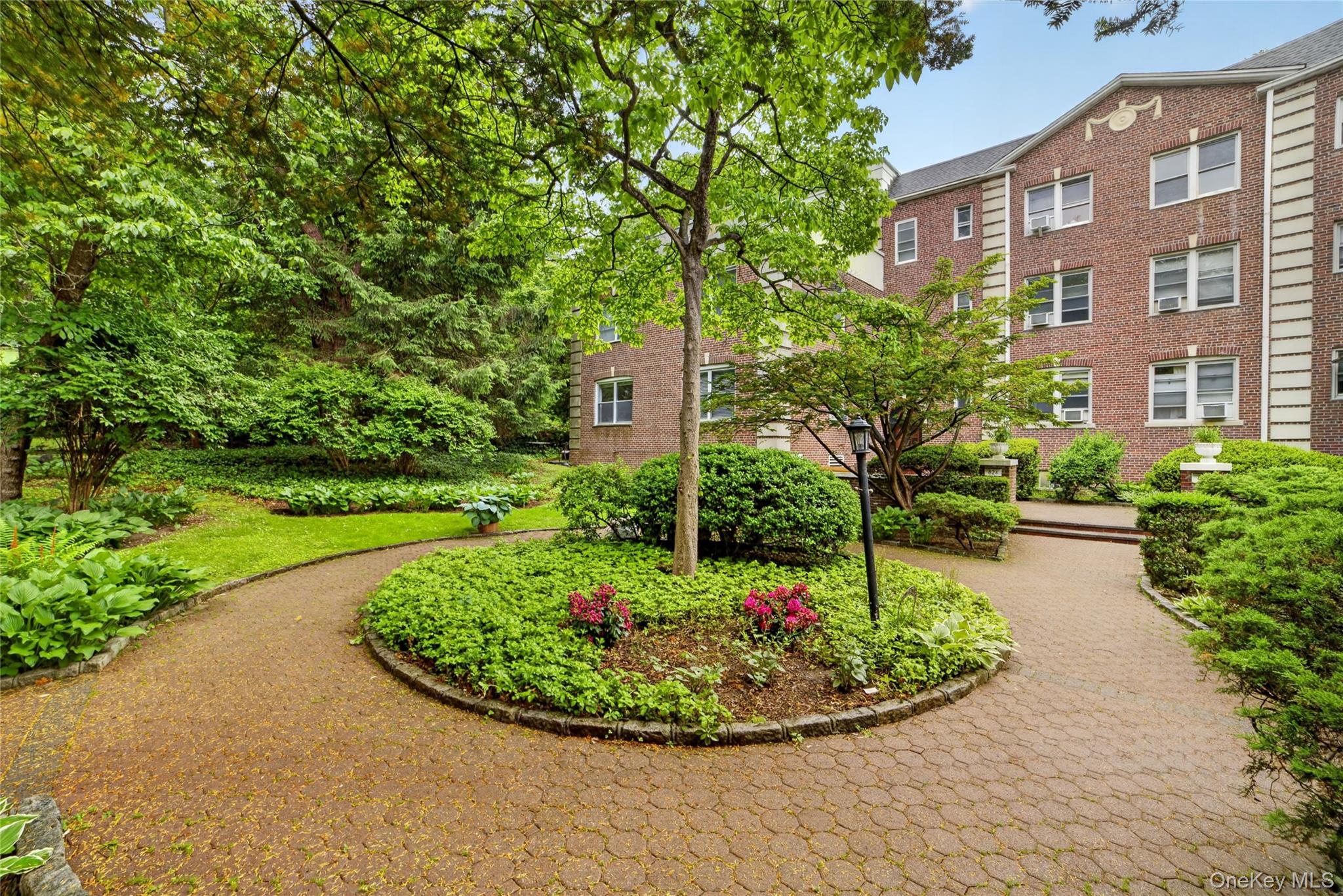 824 Palmer Road, Unit 1F Bronxville, NY 10708 - Photo 22 of 26 a view of a garden with a fountain