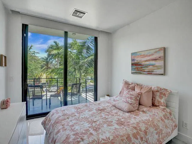 a bedroom with a large bed and a large window