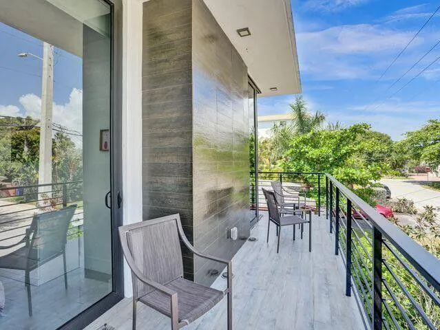 a balcony with table and chairs