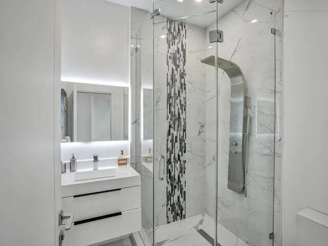 a bathroom with a shower and a sink