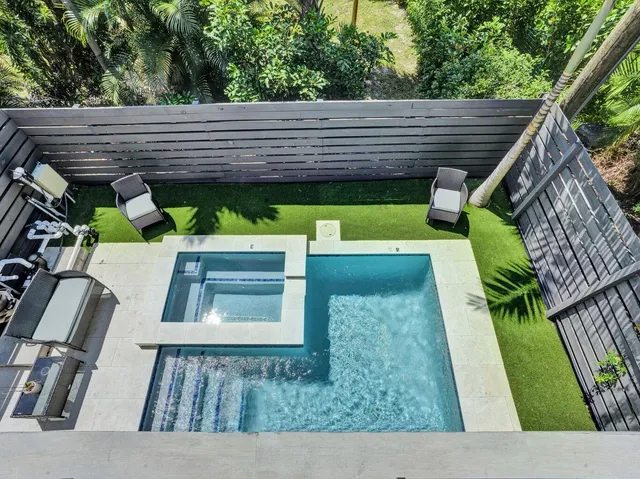 a view of a backyard with a small pool