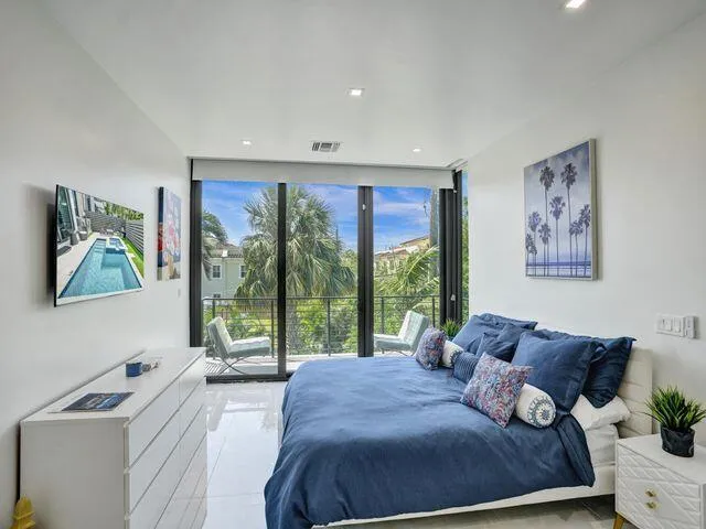 a bed sitting in a bedroom next to a window