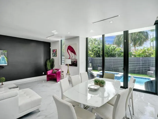 a bedroom with furniture and a large window