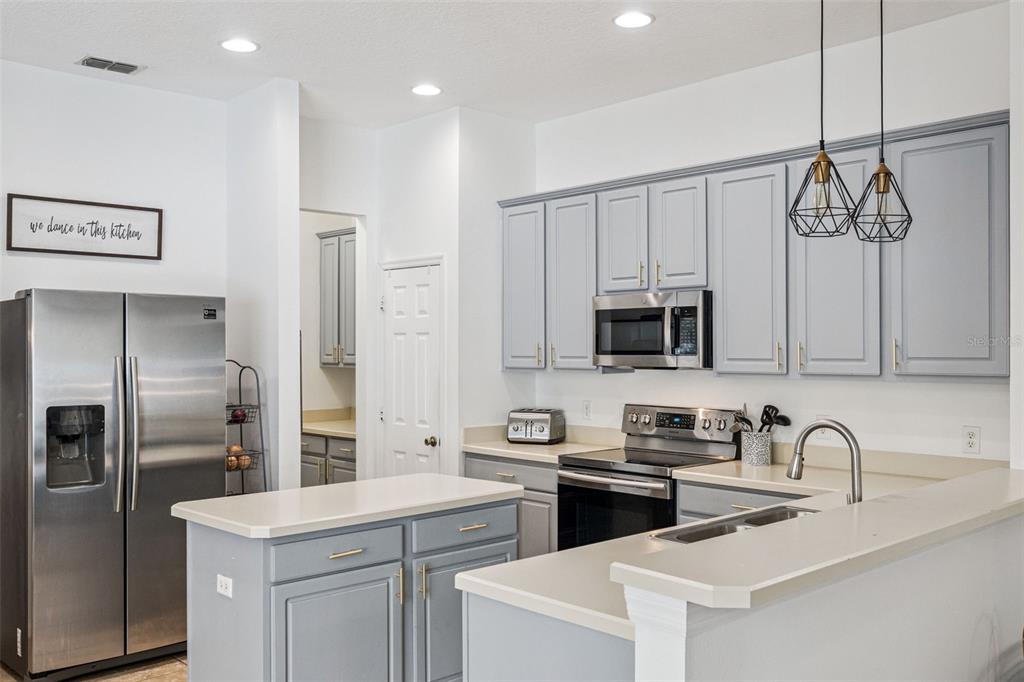 11162 Ledgement Lane Windermere, FL 34786 - Photo 14 of 55 a kitchen with stainless steel appliances granite countertop a sink a stove a refrigerator and cabinets