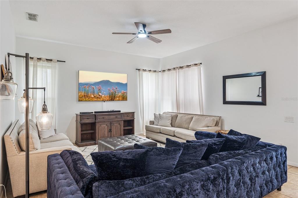 11162 Ledgement Lane Windermere, FL 34786 - Photo 17 of 55 a living room with furniture a fireplace and a flat screen tv