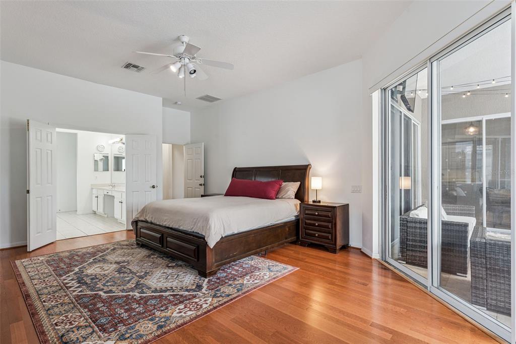 11162 Ledgement Lane Windermere, FL 34786 - Photo 19 of 55 a bedroom with a large bed and a chandelier