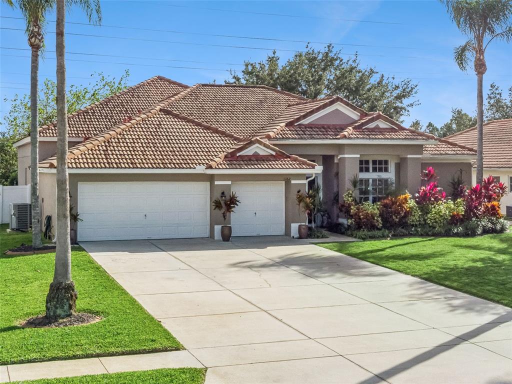 11162 Ledgement Lane Windermere, FL 34786 - Photo 2 of 55 a front view of a house with a garden and plants