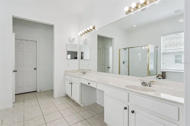 a spacious bathroom with a double vanity sink mirror and