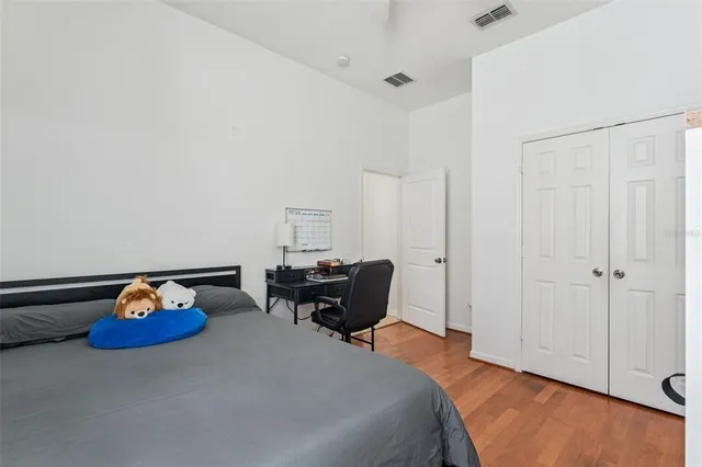 a bedroom with a bed and a desk