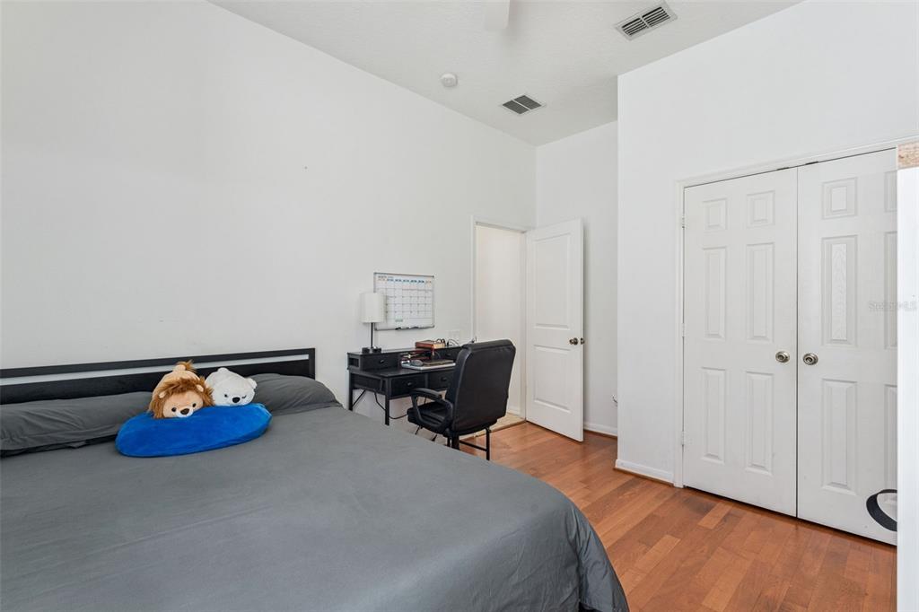 11162 Ledgement Lane Windermere, FL 34786 - Photo 24 of 55 a bed room with furniture and a wooden floor