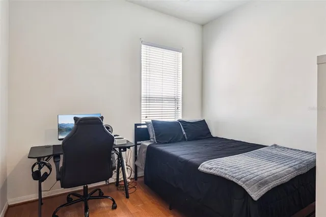 a bedroom with a bed dresser and a window