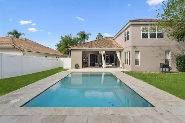 a view of house with swimming pool outdoor seating