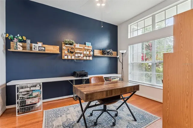 a view of a workspace with furniture and a window