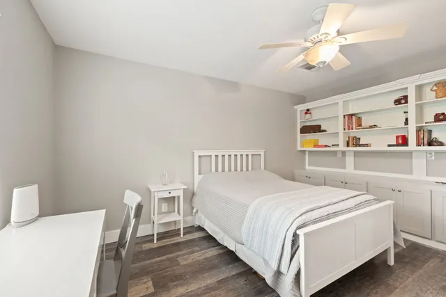 a bedroom with a bed and a table in it