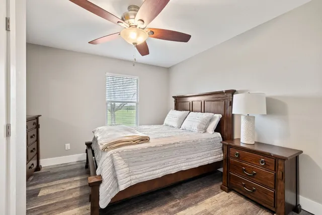 a bedroom with a bed and a ceiling fan