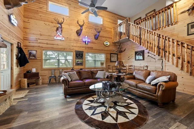 a living room with furniture a fireplace and a floor to ceiling window