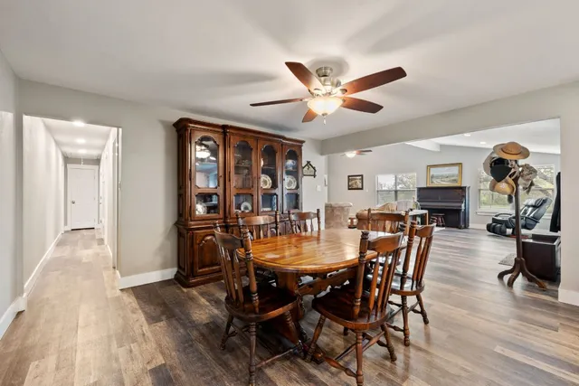 a view of a dining room with furniture and wooden floor