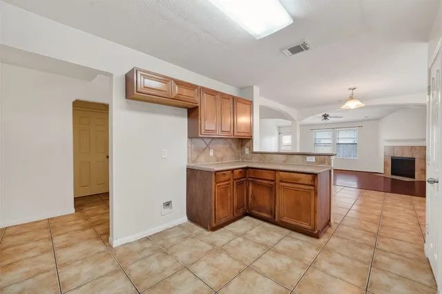 a large kitchen with stainless steel appliances granite countertop a refrigerator and a sink