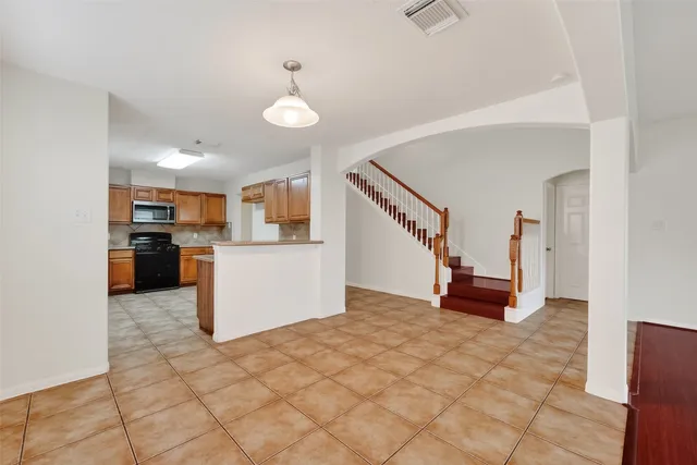 a view of kitchen with stainless steel appliances cabinets and wooden floor