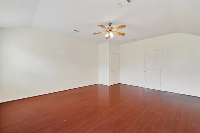a view of an empty room with a fan