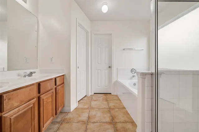 a bathroom with a sink a mirror and a shower