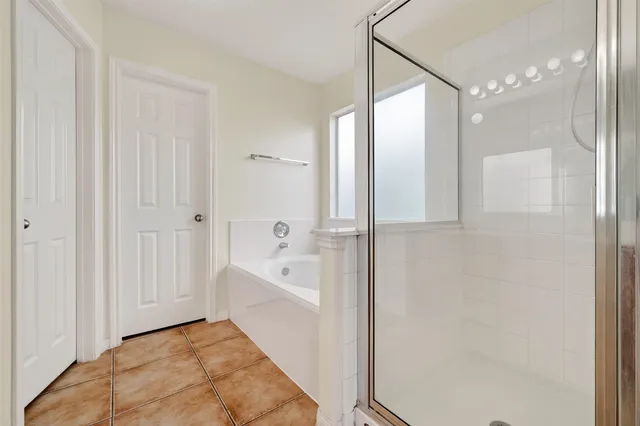 a bathroom with a bathtub and a shower