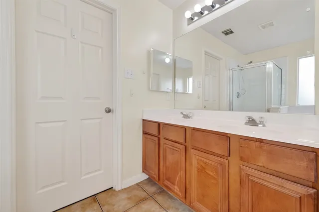 a bathroom with a double vanity sink and mirror