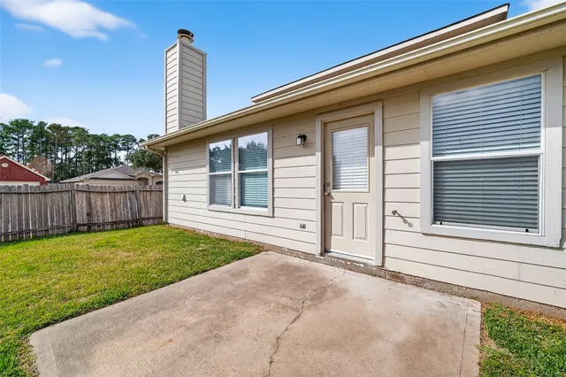 a view of a house with backyard and porch