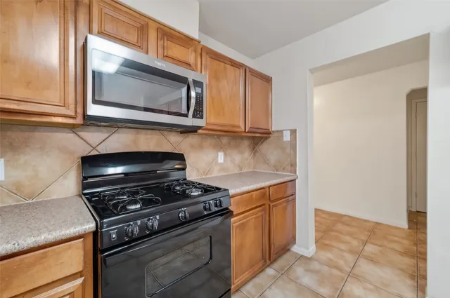 a kitchen with a stove and a microwave