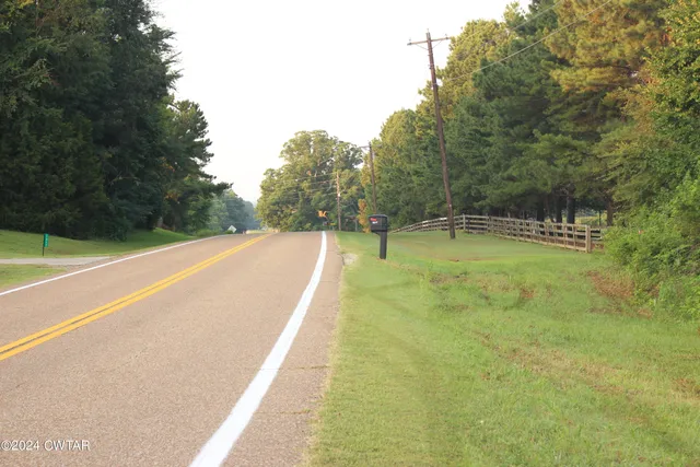 a view of a swimming pool with a yard
