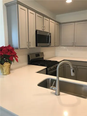 a kitchen with a sink cabinets and appliances